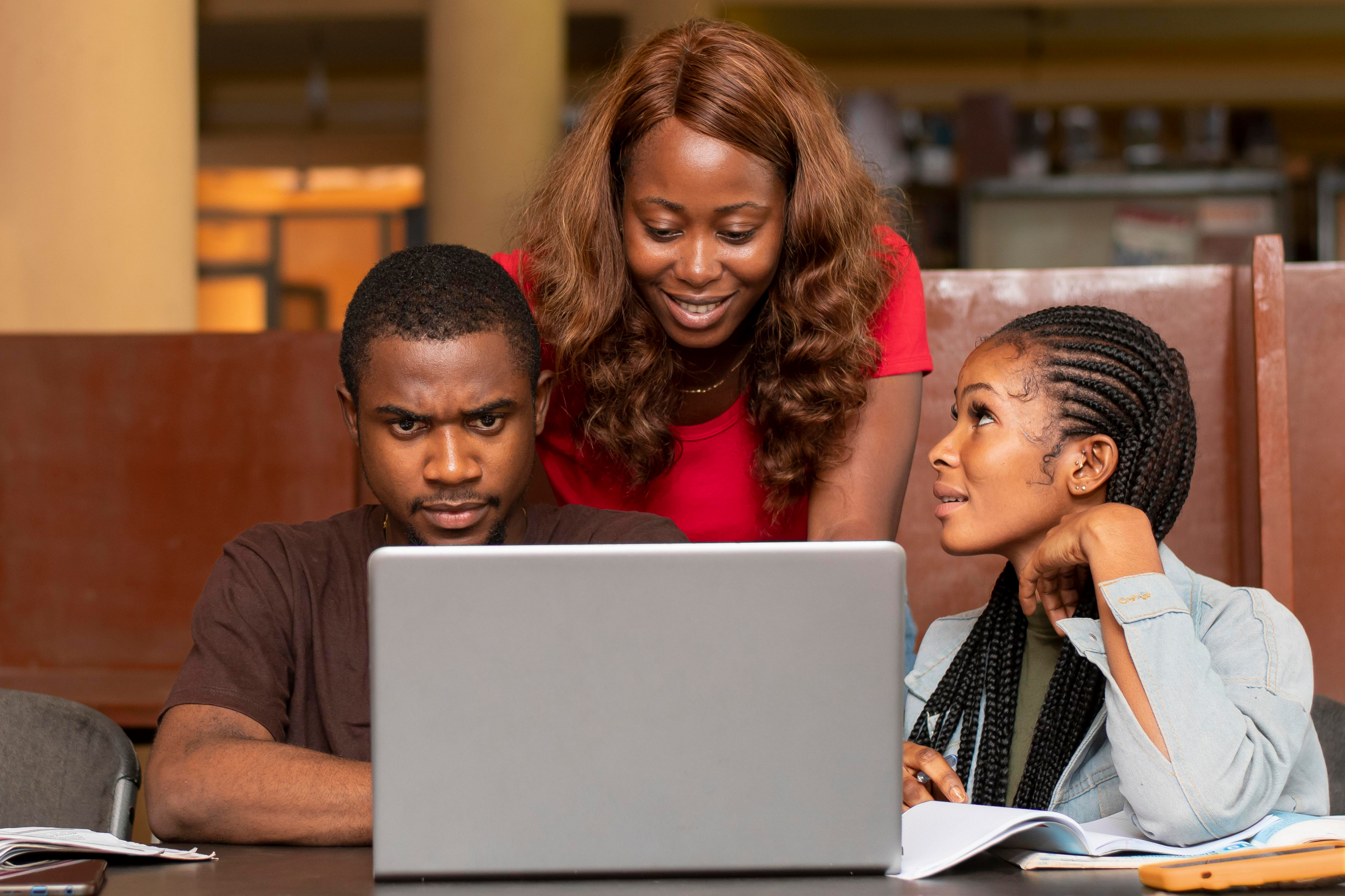 Training participants collaborating around a laptop