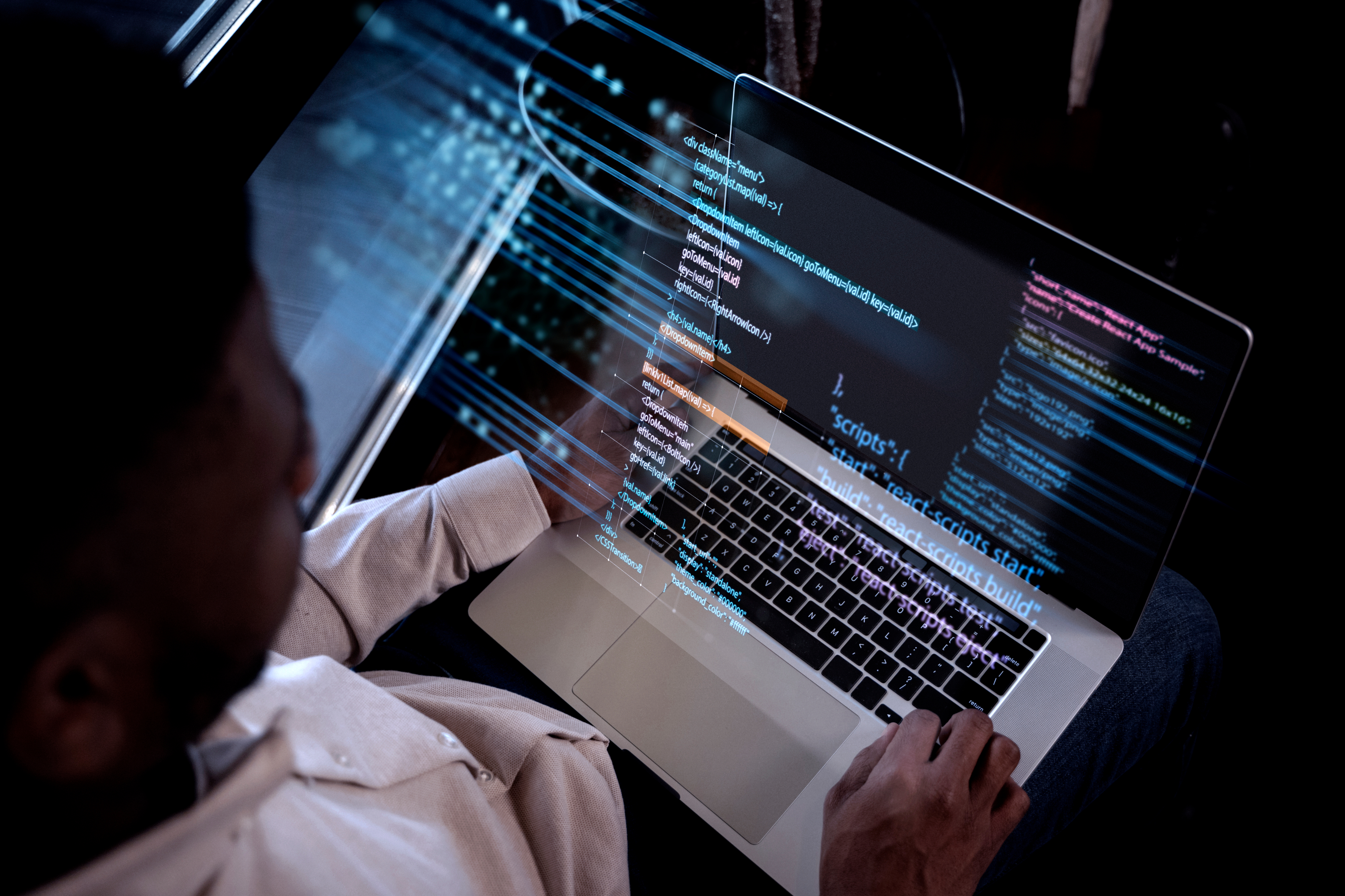 Cybersecurity professional reviewing code on a laptop